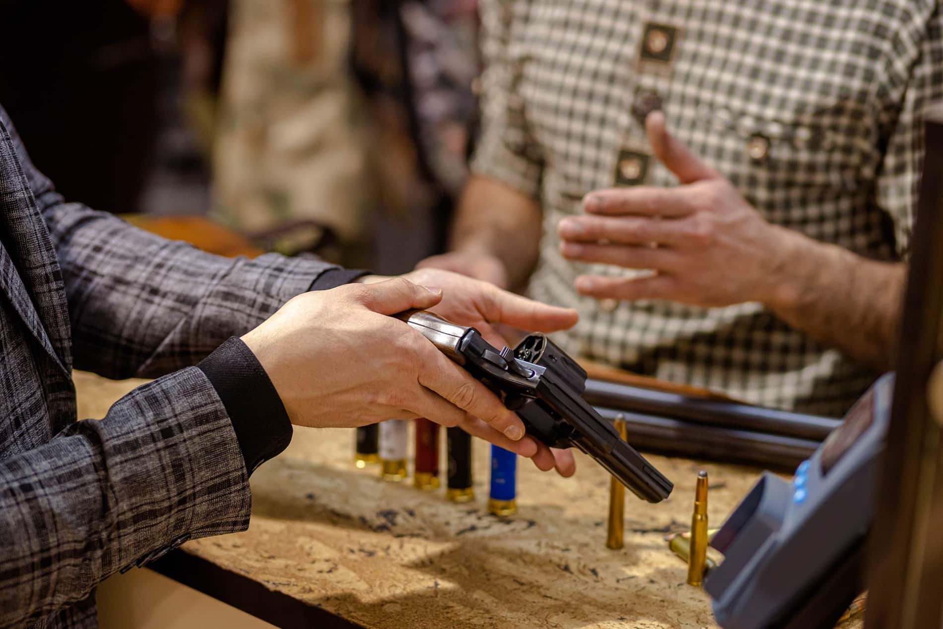 staff showing gun to customer
